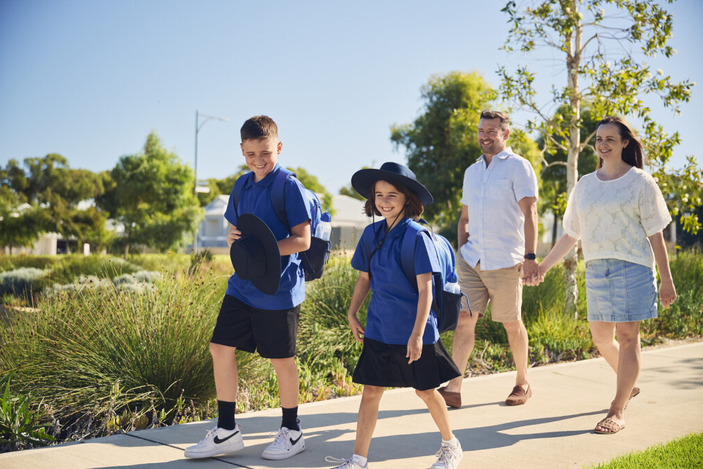 Family walking kids to school at Seaside Estate Madora Bay