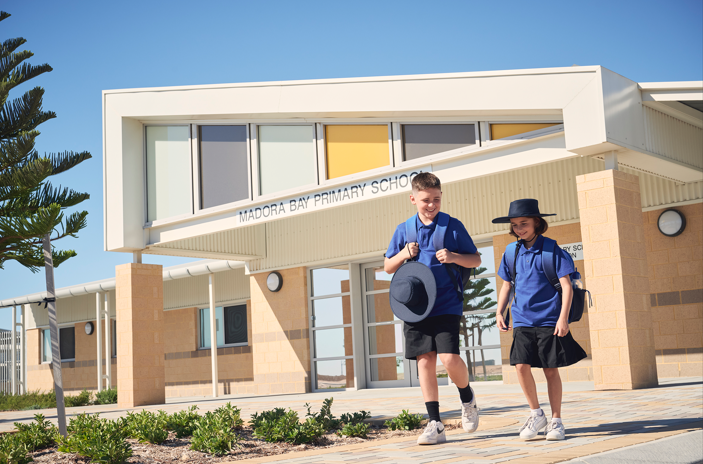 Children walking in front Madora Bay primary school, Seaside Estate